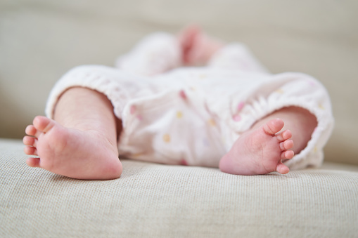 Feet of newborn baby on warm blanket