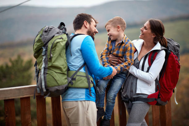 istock Young couple with son having fun on hiking 1310896510