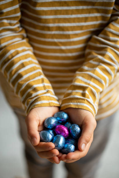 istock A boy holding blue en pink Easter eggs in his hands 1310897895