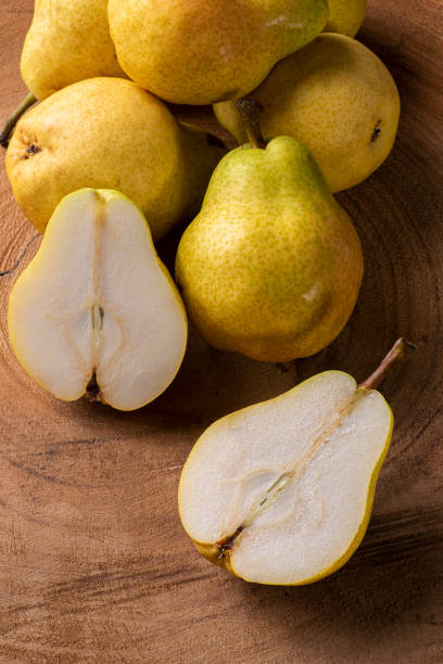 istock Pears. Some pears together on wooden background 1310898450