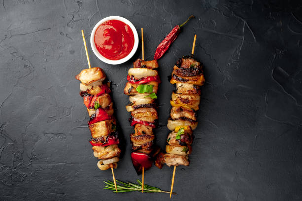 istock Meat skewers with grilled vegetables on a stone background 1310898970