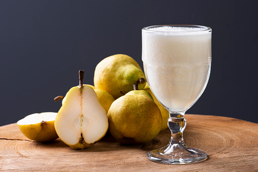 Pear Juice. Some pears together on wooden background.