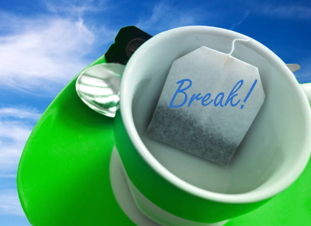 Green cup with tea bag on sky break break