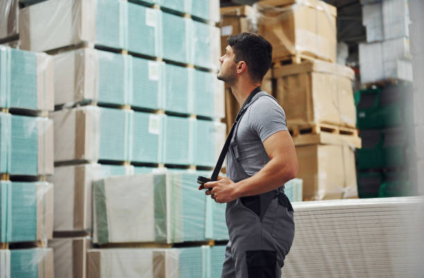 istock Storage worker in uniform and tablet in hands checks production 1310901906