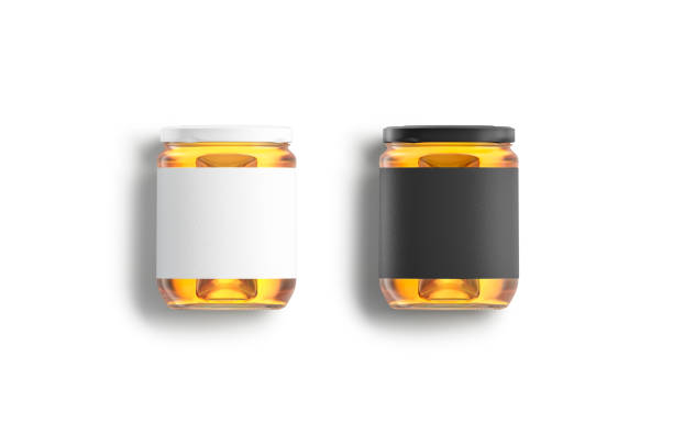 istock Blank glass jar, black and white label and honey mockup 1310902276