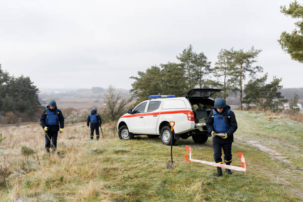 istock Men work in emergencies. Emergency workers work outdoors. A man in uniform works with a metal detector 1310902296