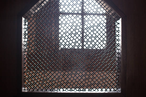 old priest inside the wooden confessional in a christian church. - confession booth imagens e fotografias de stock