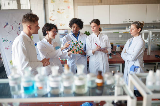 istock Young chemical students learning on molecule model in the university laboratory. Science, chemistry, lab, people 1310904973