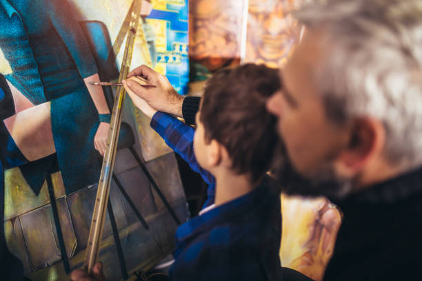 istock Father and son working and painting together in art studio 1310905274