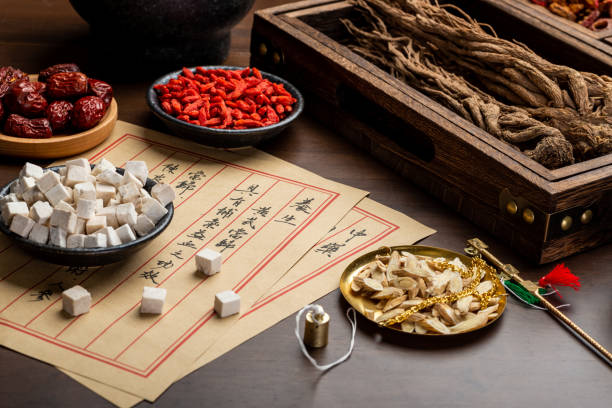 istock Ancient Chinese medicine books and herbs on the table 1310905291