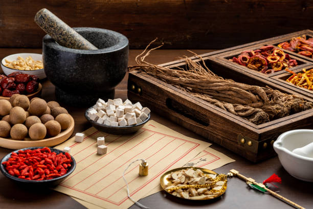istock Ancient Chinese medicine books and herbs on the table 1310905502