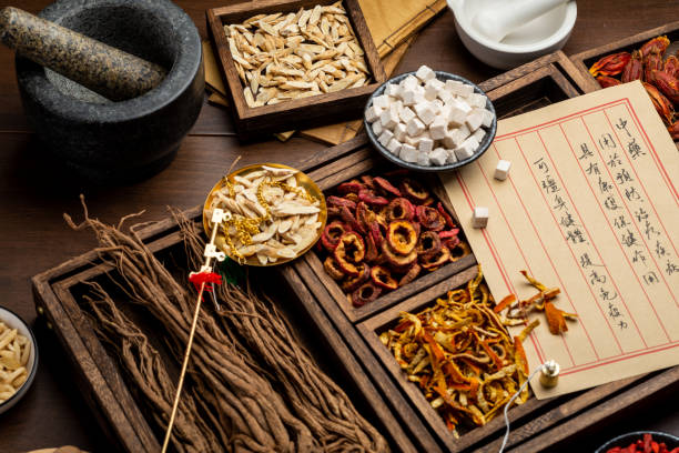 istock Ancient Chinese medicine books and herbs on the table 1310905532