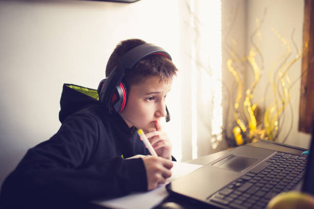 istock Teenage boy using laptop for homework 1310906482