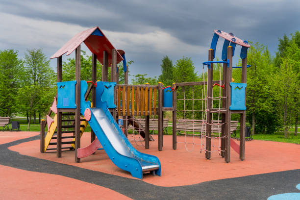 istock empty kids play ground in public park, rainy weather 1310906683