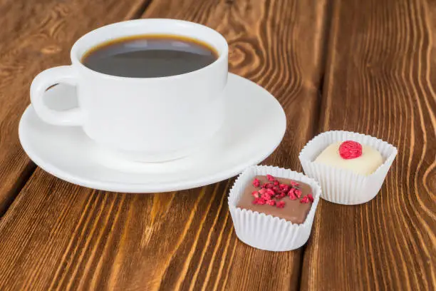 delicious various homemade chocolate candies with coffee cup on wooden table