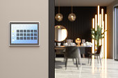 Smart Home Control System With App Icons On A Digital Screen In Dining Room With Blurred Background