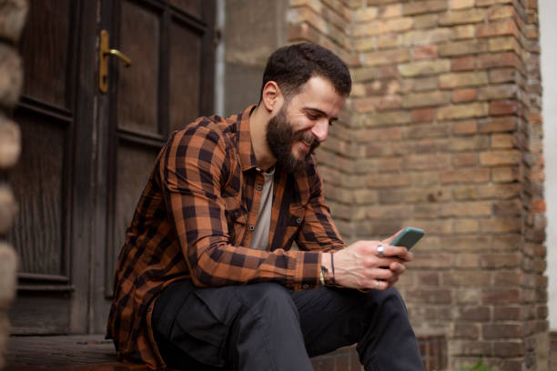 istock Happy young Caucasian man using a smart phone 1310909367