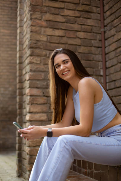 istock Young Caucasian woman using a smart phone 1310909377