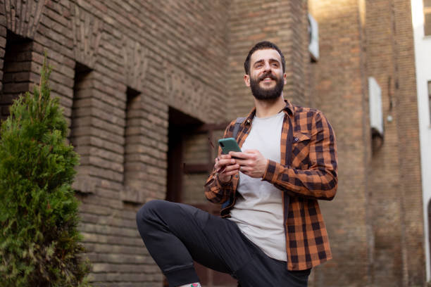 istock Happy young Caucasian man using a smart phone 1310909532