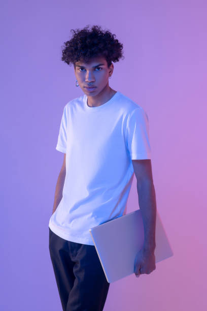 istock African american young guy in white tshirt with a laptop 1310911317