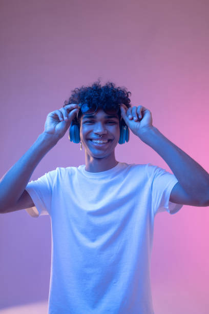 istock Dark-skinned guy in headphones smiling nicely and looking happy 1310911388
