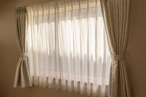 istock Glass window and lace fabric curtain 1310911634
