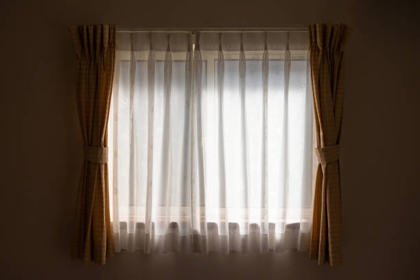 istock Glass window and lace fabric curtain 1310911637