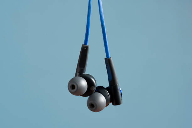 istock headphone hanging with sound waves on blurred background 1310912193