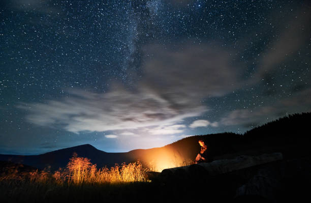 istock Man is relaxing in forest near bonfire. 1310912194