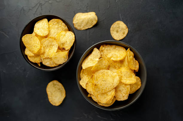 istock potato chips in a bowl, beer snacks on a stone background 1310913141