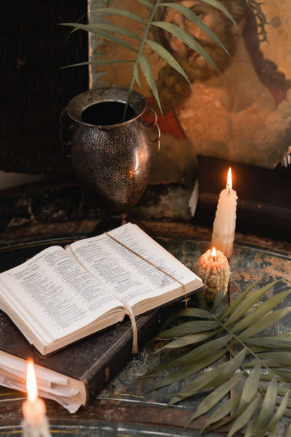 istock candles, paited eggs, willow branches and bible. vintage icon. easter at home 1310914764