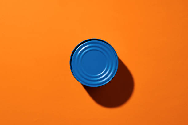 istock Aesthetic concept with blue painted tin can on orange background 1310915984