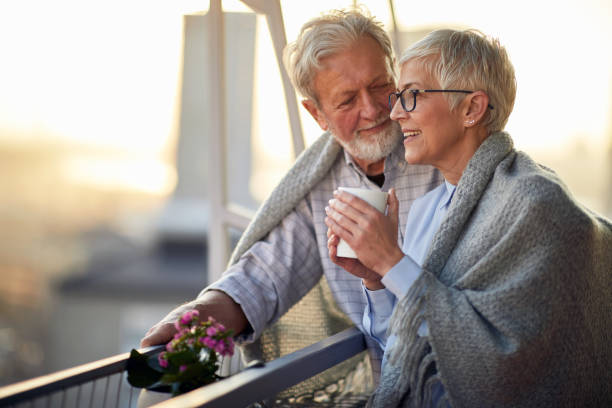 istock An elderly hugged couple in love spending a wonderful time together while enjoying a beautiful sunset from the terrace of their apartment. Relationship, love, together 1310916306