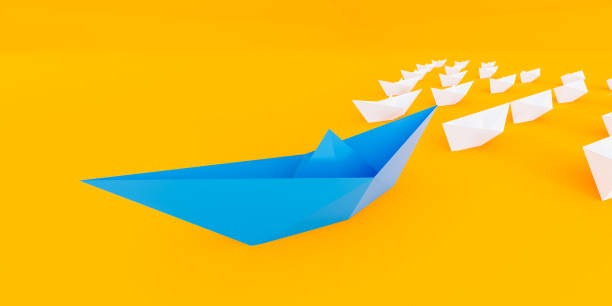 istock Innovative business solution concept. Group of white paper ships in one direction and leading one red paper ship. 1310917755