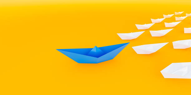 istock Innovative business solution concept. Group of white paper ships in one direction and leading one red paper ship. 1310917756