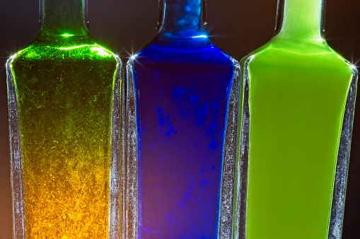 Abstract coloured colored bottles on a black background