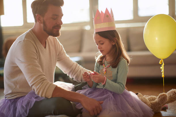 istock Happy dad and daughter dressing up toghether 1310920036