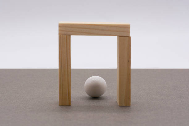 istock a white ball surrounded by wooden blocks on a gray background. Deadlock, search for a solution 1310920302