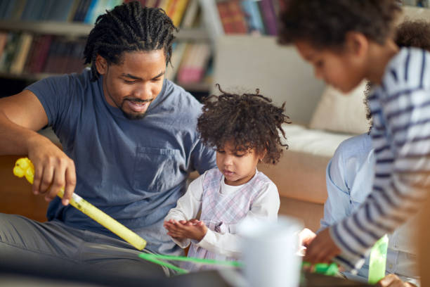 istock Cheerful afro american parents playing with their daughter 1310924500