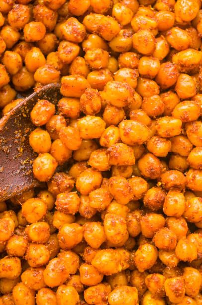 istock Cooking chickpeas with spices in a pan, close-up 1310924886