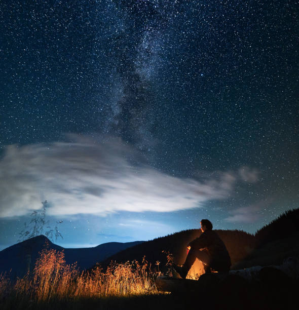istock Man is relaxing in forest and watching night sky. 1310925998