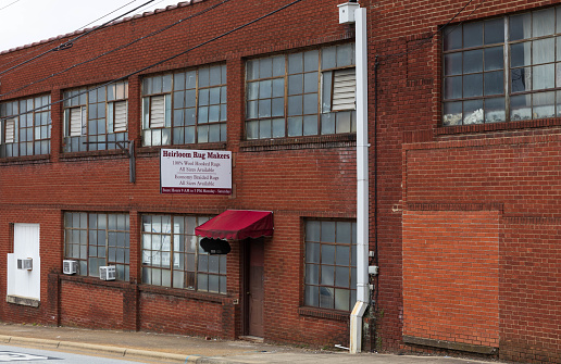 Office space for rent along the river district in Haverhill Massachusetts, September 2022. Large brick old factory warehouse building converted to office space for rent along the Merrimack river in Haverhill.