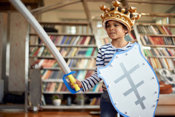 istock A cheerful little boy posing with a sword and a shield while playing at home. Family, home, playtime 1310927356