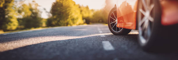 istock Red car on asphalt road in summer 1310928700