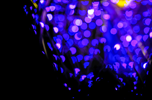 wonderful bokeh in circle and heart shape light violet or purple color in night black background.