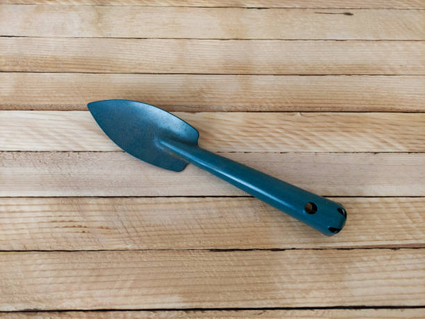 istock Garden shovel on light wooden background 1310929698