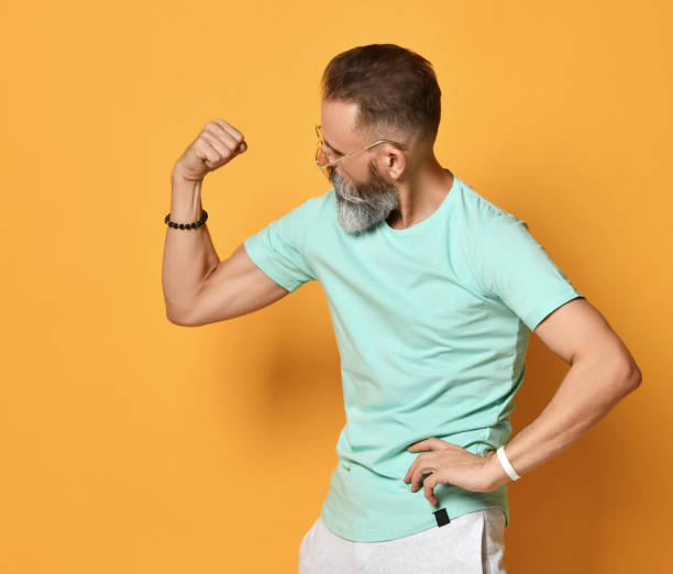 istock Brutal bearded man showing muscle power gesture studio shot 1310929741