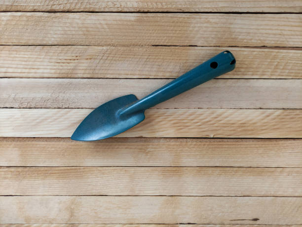 istock Garden shovel on light wooden background 1310929788