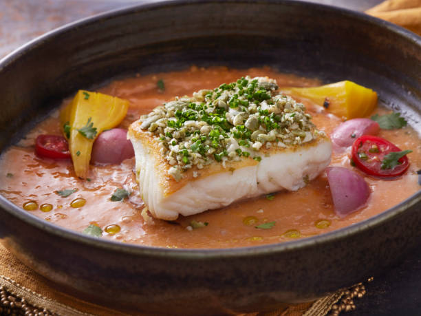 istock Pan Seared Halibut with Pumpkin Seed Gremolata with a Coconut Curry Sauce 1310931247