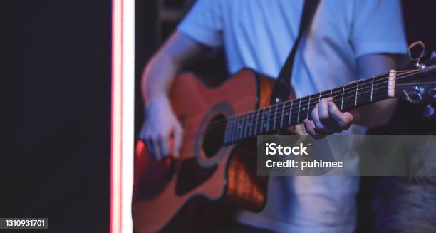 Close Up Of A Guitarist Playing An Acoustic Guitar In A Dark Room Copy Space Stock Photo - Download Image Now